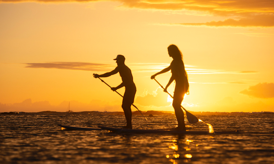 couple paddleboard in the ocean